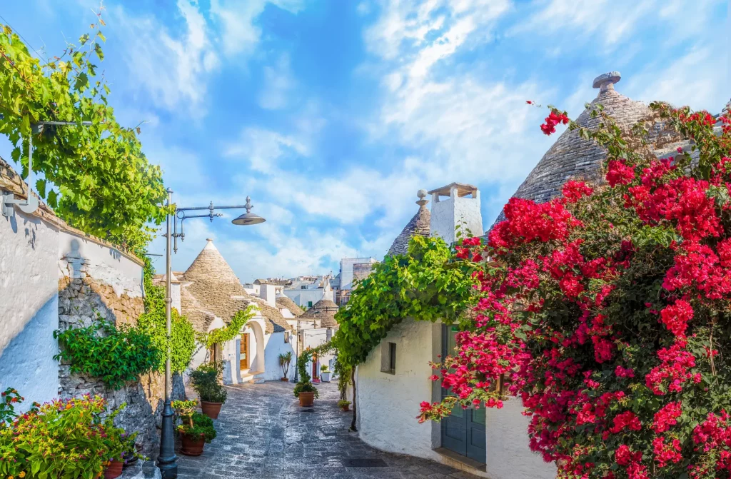 Charming white stone houses with conical roofs in Puglia, Italy.