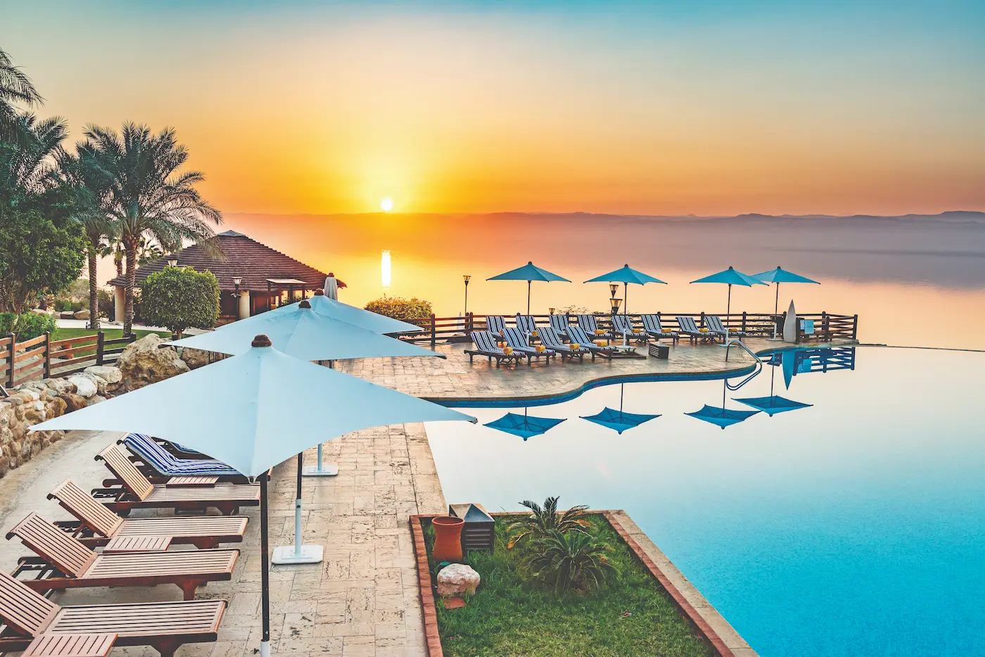 Jordan infinity pool with umbrellas by the sea hosted by GHardy luxury tours